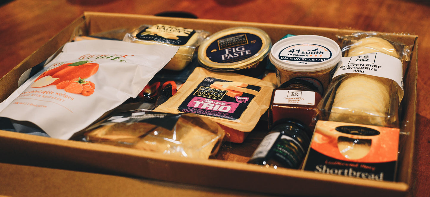 Photograph of yummy Taste of Tasmania tray items like smoked salmon, cheeses, crackers, and quince paste