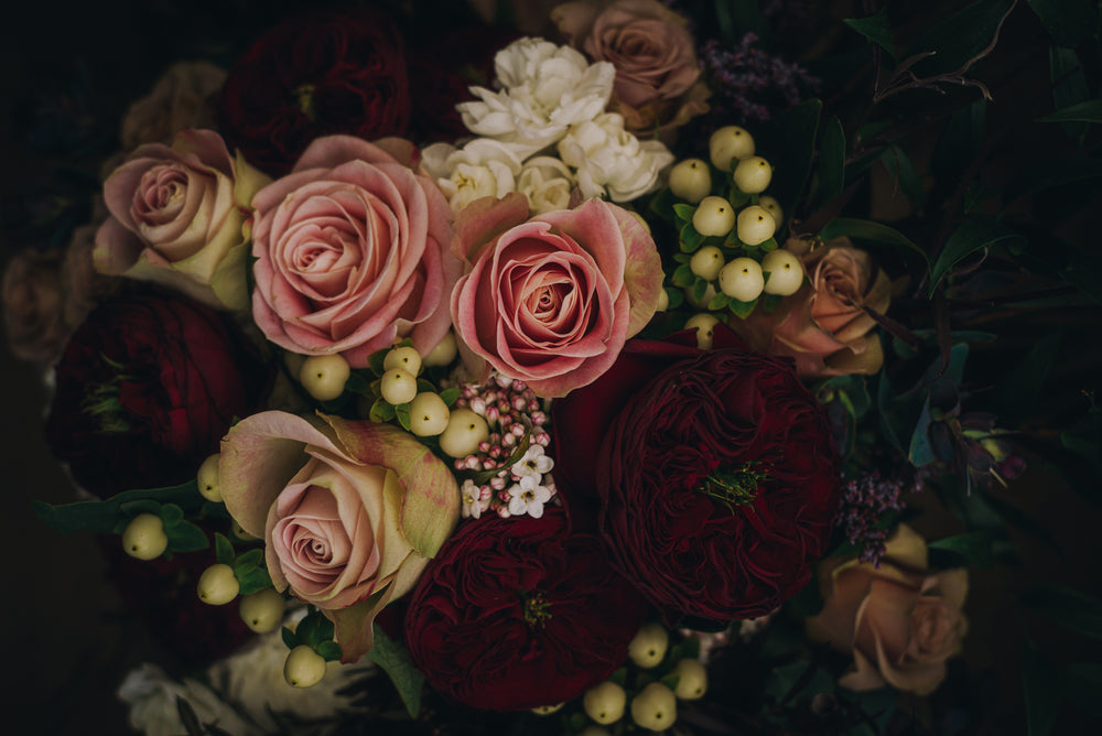 Photograph of luscious pink roses and dark red peonies