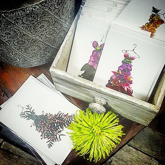 
                  
                    Photograph of an assortment of greeting cards of flower petals in the shape of dresses
                  
                