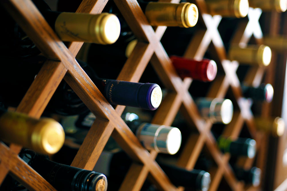 Photograph of diagonal wine rack containing many bottles of wine of all types